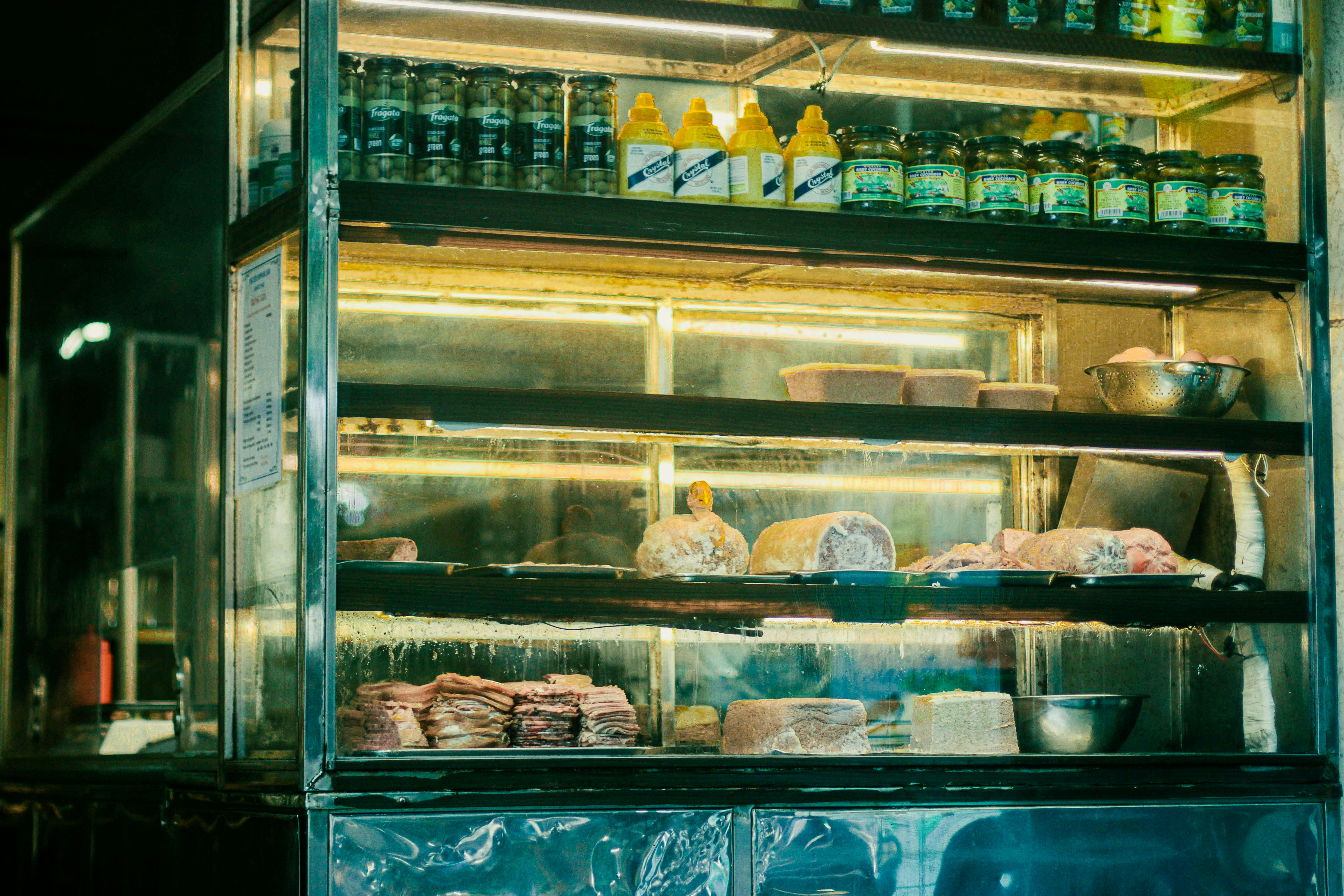 A lit street food case late at night