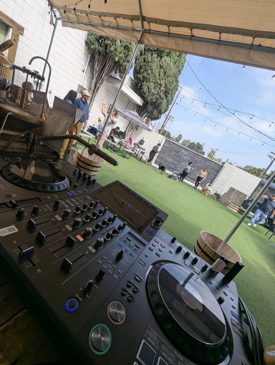 DJ controller set up on site with the venue behind