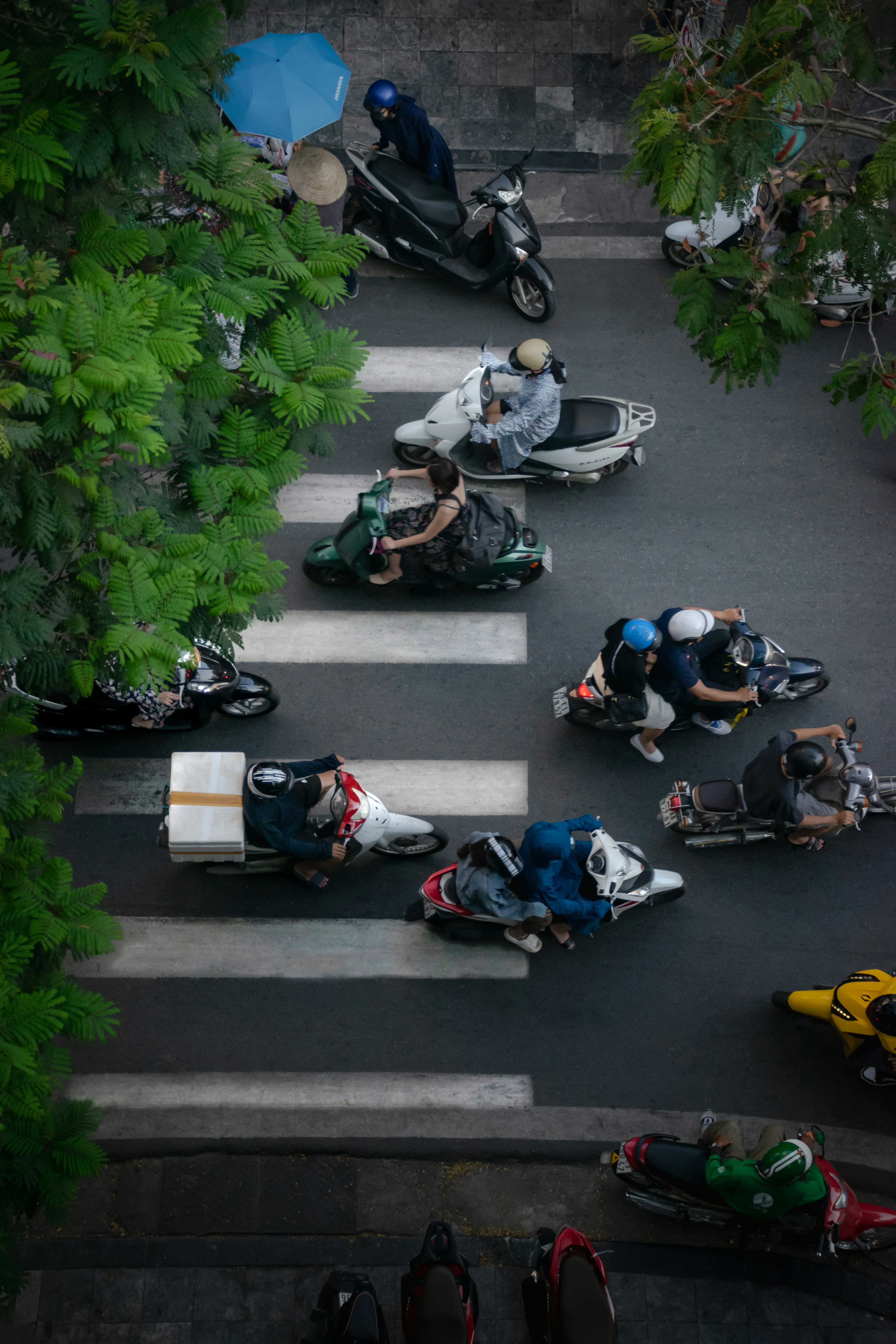 Motorbikes at a crosswalk seen from above