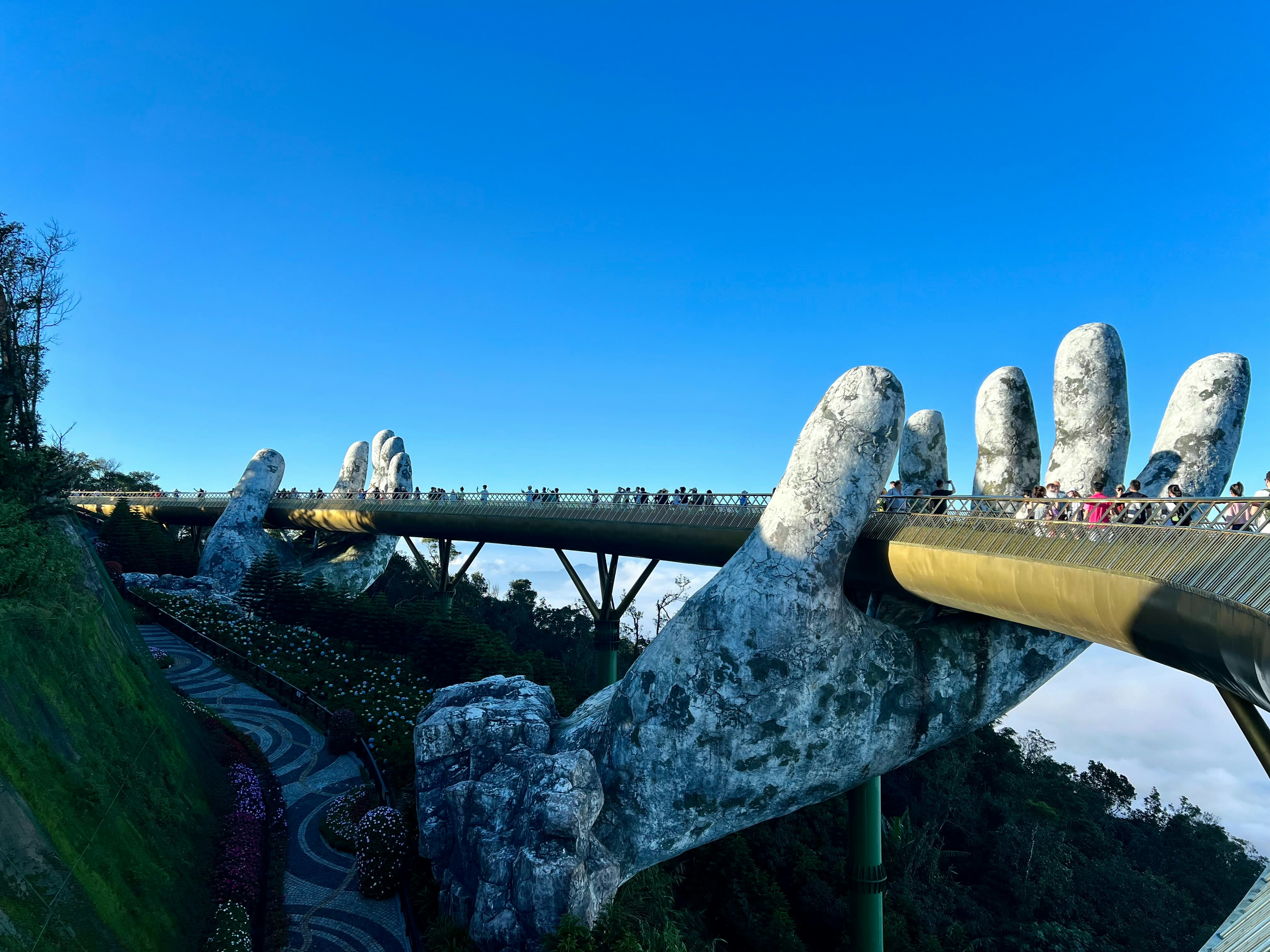 The Golden Bridge held up by giant stone hands