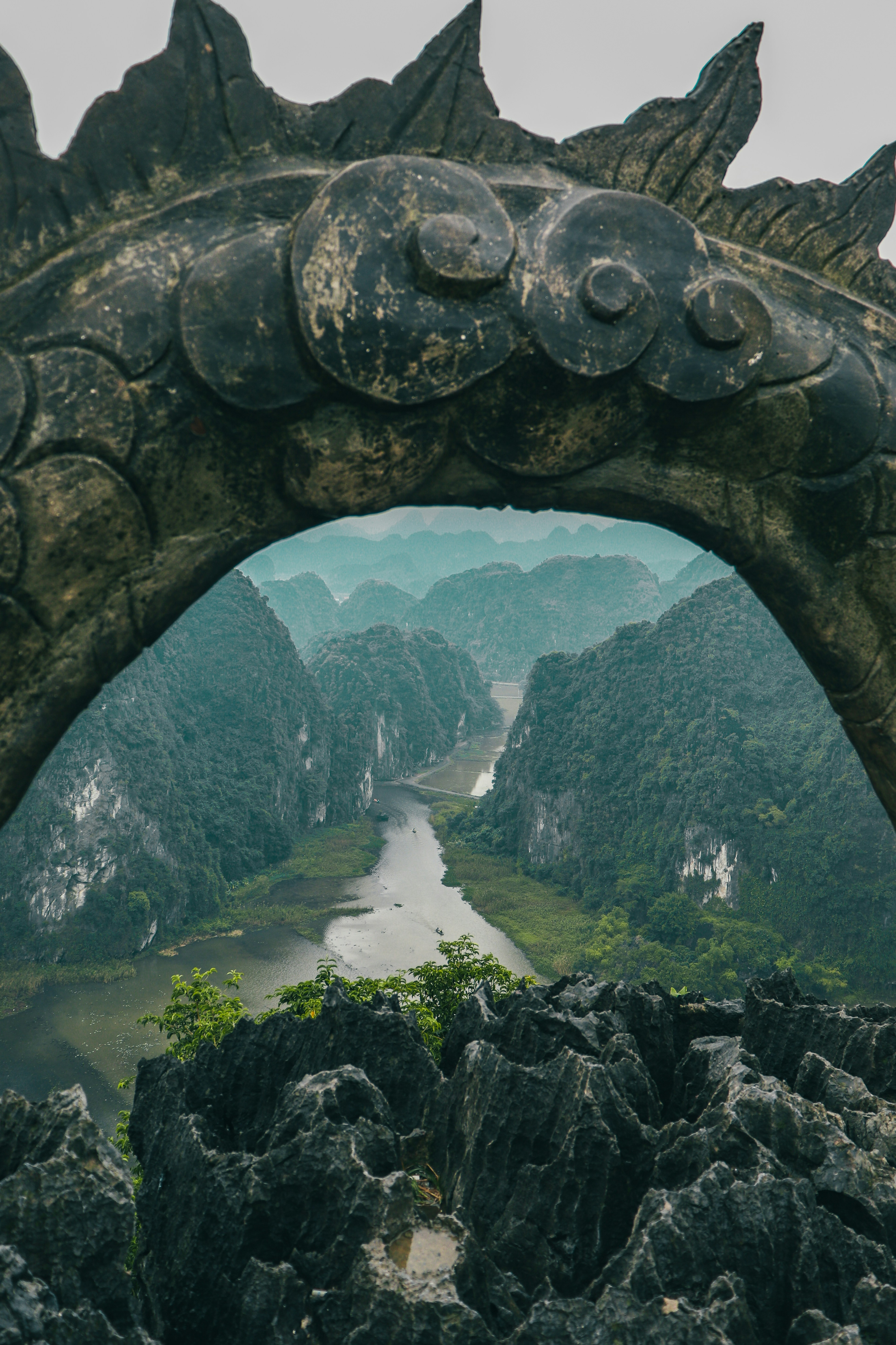 The Tam Cốc valley framed by a carved stone dragon