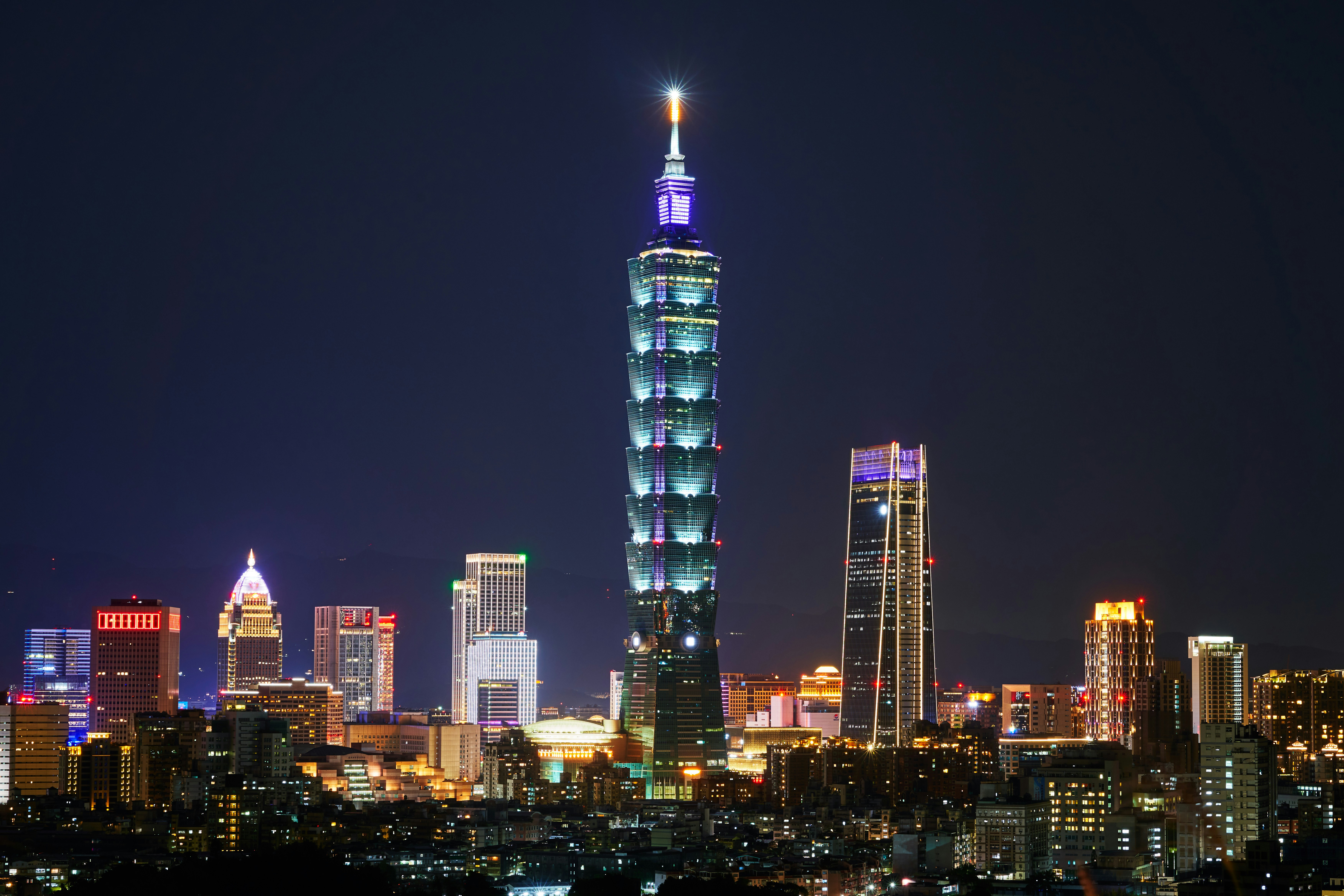 Taipei 101 lit above the city at night